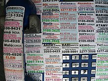 Stickers affixed to a payphone in Sao Paulo, 2006 Prostitutoin Adverts.jpg