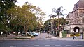 George Street entrance to the Queensland University of Technology Gardens Point campus. The City Botanic Gardens are at the left, and Parliament House is at the right