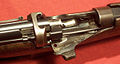 A Lee-Enfield Mk III rifle with the bolt pulled back. The bolt lugs lock into the receiver bridge and are rear-locking.