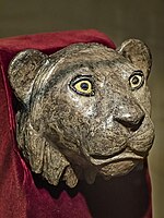Silver lioness head finial for the arm of a chair with shell and lapis lazuli inset eyes, recovered from the royal cemetery of Ur 2550–2450 BCE, from the death pit at the entrance Puabi's chamber[19]