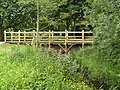 Footbridge on lower section of the walk, at Longford, by the Poolhouse Estate. It was modelled on the bridge on which A. A. Milne's characters played Poohsticks.