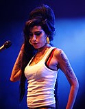 Visible bra strap of Amy Winehouse at a performance, France.