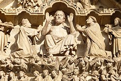 A sculpture depicting the final judgement of sinners by Jesus at Amiens Cathedral, a World Heritage Site. Cathedrale d'Amiens, facade - detail.JPG