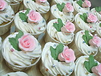 Cupcakes topped with frosting and gumpaste flowers
