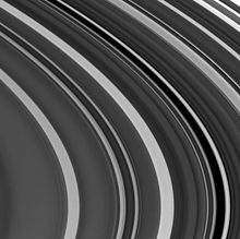 View of the outer C Ring; the Maxwell Gap with the Maxwell Ringlet on its right side are above and right of center. The Bond Gap is above a broad light band towards the upper right; the Dawes Gap is within a dark band just below the upper right corner. PIA06540 Outer C Ring.jpg