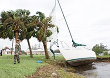 A U.S. Navy member assesses a damaged sailboat in Jacksonville, Florida 330-CFD-DN-SD-05-06017 (36793413510).jpg