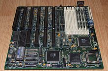 The Octek Jaguar V motherboard from 1993. This board has few onboard peripherals, as evidenced by the 6 slots provided for ISA cards and the lack of other built-in external interface connectors. Note the large AT keyboard connector at the back right is its only peripheral interface. 386DX40 MB Jaguar V.jpg