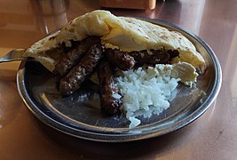 Bosnian ćevapi served with local pitta variety called somun