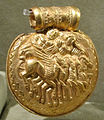 Jupiter and Minerva riding a quadriga drawn by pegasi on a 4th-century BC gold Etruscan bulla (Museo Gregoriano Etrusco)