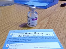 AstraZeneca vaccine vial and a NHS patient COVID-19 vaccination record card at a NHS vaccination centre COVID-19 AstraZeneca Vaccine vial and NHS record card.jpg