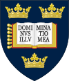 A shield displaying a coat of arms; on a dark blue background, an open book displays the words "Dominus illuminatio mea", with two gold crowns above and one below