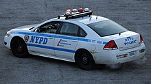 A New York Police Department (NYPD) cruiser. The NYPD is the biggest municipal police force in the world. NYPD Chevrolet Impala of the 105th Pct, rear.jpg