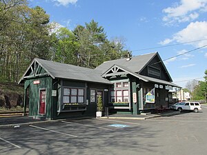 A green wooden railway station building