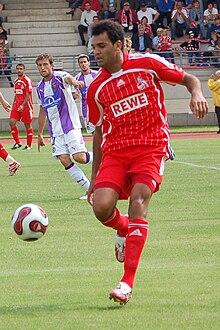 Roda Antar, wearing a red 1. FC Köln kit, controlling the ball during a football game