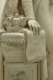 The Belgian crown symbolically resting on the constitution in a nineteenth-century statue of Leopold I The Belgian Constitution-Leopold I.JPG