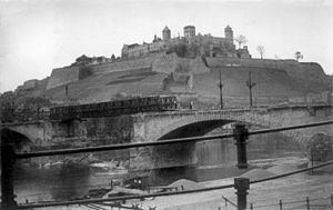 Bailey bridge built over bombed out bridge at base of Marienberg Fortress in Wurzburg by the 119th Armored Engineer Battalion of the U.S 12th Armored Division, April 1945 119th Armored Engineer Battalion Wurzburg fortress Baily Bridge.jpg