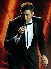 A color photograph of singer Michael Bublé performing live in 2013.