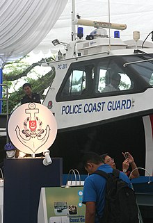 Booth of the Police Coast Guard at the Police Carnival 2006 showing its old logo with a PC boat in the background Police Coast Guard Booth.jpg