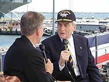 Tony Snow interviewing John Warner in 2003 US Navy 030712-N-8268S-309 Senator John W. Warner, Chairman of the Armed Services Committee is interviewed on live television by Tony Snow of Fox News Network.jpg