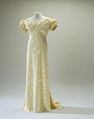 1938 – Champagne-colored silk evening gown with stylized silver-colored leaves.