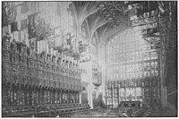 Stalls of Knights of the Garter in St George's Chapel. The Garter stall plates are visible affixed to the rear panelling of each stall Wood Carvings in English Churches II-071.jpg