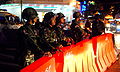 Soldiers with riot shields at a barricade on Silom Road and Soi Convent