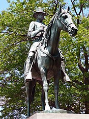 A color photograph depicting a statue of a man on a horse