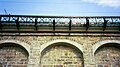 Canton Viaduct coping - A row of granite coping can be seen projecting 6" beyond the wall between the granite deck arches and the new concrete deck.