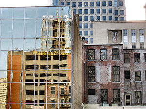 Blight often stands side-by-side with new structures during urban renewal efforts. Note the reflection of the new construction in progress.