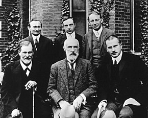 Group photo 1909 in front of Clark University. Front row: Sigmund Freud, G. Stanley Hall, Carl Jung. Back row: Abraham Brill, Ernest Jones, Sandor Ferenczi. Hall Freud Jung in front of Clark 1909.jpg