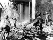 A Japanese soldier surrendering to three U.S. Marines in the Marshall Islands during January 1944. Japanesesurrendermarshallislands.jpg