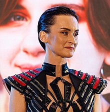 Image of Pavlenko with short hair and a black and red dress with studs