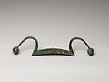 Chinese bronze rein holder, ca. 11th century BCE. The span is 38.7 cm.[7]