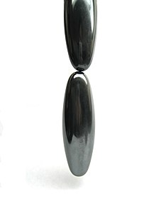 Ovoid-shaped magnets (possibly hematine), one hanging from another The Effects of Magnetism.JPG