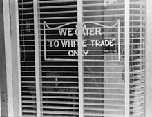 A sign reading "We Cater to White Trade Only"