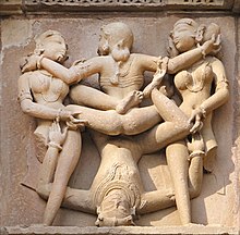 Khajoraho scene of three women and one man 1 Erotic Kama statues of Khajuraho Hindu Temple Kandariya Mahadeva Khajuraho India 2013.jpg