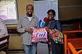 Presenting the throw pillow to librarian with the highest number of contributions at Kenneth Dike Library, UI