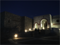 Night-time view from lower courtyard toward main chapel and upper courtyard entrance.