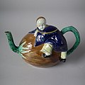 Coloured glazes Oriental Boy on Coconut Teapot and cover c 1870.