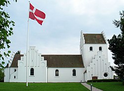 A Church of Denmark parish church in Holte, with the Dannebrog flying in its churchyard Holte Kirke 2005.jpg