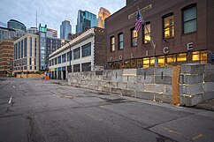 Minneapolis first police precinct building protected by a temporary wall, June 9, 2020 Minneapolis Police, First Precinct (50038383321).jpg