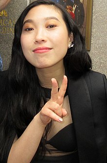 Awkwafina giving a peace sign