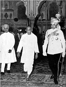 Sardar Patel (centre) leaving the Durbar Hall in Jaipur after the inauguration of the Rajasthan Union in 1949. On the right is Man Singh II, the Maharaja of Jaipur and the first Rajpramukh of the Union; on the left is the Maharaja of Kotah Sardar after inaugrating Rajasthan.jpg