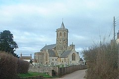 Stone building with hexagonal tower topped by a short spirelet.