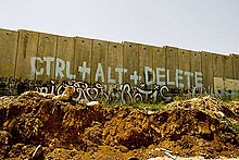 Graffiti on the Israeli West Bank barrier wall. Graffiti can function as an open or public challenge to colonial and imperialist structures. The barrier -graffiti painted - West Bank - Palestine.jpg