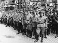 18 рейхсляйтерів (у першому ряду) на 10-у партійному з'їзді (Нюрнберг, вересень 1938). Справа наліво: Мартін Борман, Роберт Лей, Вільгельм Фрік, Ганс Франк, Франц фон Епп, Йозеф Геббельс, Вальтер Бух.