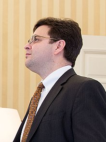 Photograph of Ricardo Zúñiga facing away from the camera in the White House