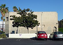 Recording studio with a car park and a tree.