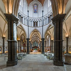 The interior of the Round Church facing east towards the chancel. Medieval tomb effigies are on either side of the centre aisle. Temple Church 5, London, UK - Diliff.jpg