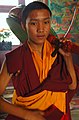 Young Tibetan Drummer with his drum on his shoulder gets prepared to play on Bodhisattva Day!